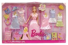 a barbie doll in a pink box with clothes and accessories on the shelf next to it