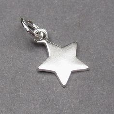 Sterling silver star pendant charm. The finished dangles measures 16mm x 10mm with a 6mm open jump ring. Stock 7. MORE SILVER CHARMS: https://www.etsy.com/shop/TheDangleDiva?ref=hdr_shop_menu&section_id=12085195 WIRE WRAPPED Pendants: https://www.etsy.com/shop/TheDangleDiva?section_id=8145875&ref=shopsection_leftnav_1 FOLLOW me: www.facebook.com/thedanglediva for new designs and discount coupons INTERCHANGEABLE EARRINGS: https://www.etsy.com/shop/TheDangleDiva?ref=hdr_shop_menu&secti Sterling Silver Star-shaped Charms, Silver Star Sterling Silver Charms, Silver Sterling Silver Star Charms, Silver Star-shaped Sterling Silver Charms, Silver Star-shaped Jewelry With Dangling Charms, Silver Star Charm With Celestial Style, Silver Star Charm Celestial Charms, Silver Star Charm Celestial, Silver Celestial Star Charm