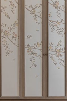 an armoire with flowers painted on the side and leaves drawn on the back wall