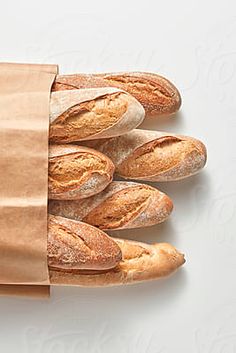 a bunch of bread in a brown paper bag