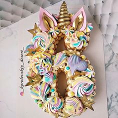 an elaborately decorated cookie in the shape of a unicorn