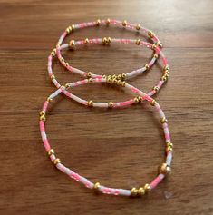 Neon pink, white & gold themed bracelet stack. Pink Beaded Letter Bracelets Bangle, Pink Beaded Bangle Bracelets With Letter Beads, Pink Beaded Bangle Bracelet With Letter Beads, Pink Letter Beads Bangle Bracelet, Pink Wrap Bracelet With Round Beads For Gifts, Pink Letter Beads Friendship Bangle, Adjustable Pink Stackable Friendship Bracelets, Adjustable Stackable Pink Friendship Bracelets, Trendy Handmade Pink Wrap Bracelet