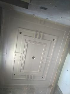 an unfinished ceiling in the middle of a room with white walls and floor tiles on it