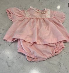 Adorable pink vintage dress with matching bloomers. The dress has lace accents on the front. The bloomers are all pink.  No tags in the item so manufacturer and exact size is unknown. Looks rather small so recommend for 0-3 months. Pink Lace Trim Sets For Spring, Vintage Pink Spring Sets, Sweet Pink Sets With Ruffles, Pink Cotton Bloomers With Ruffles, Vintage Ruffle Sets For Summer, Vintage Ruffled Sets For Summer, Vintage Ruffled Summer Sets, Cute Pink Sets For Daywear, Pink Vintage Dress