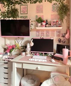 a desk with two computer monitors, keyboard and mouse on it in front of some plants