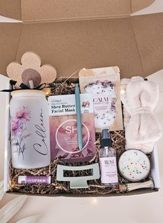 an open box containing personal care products and beauty items, including soaps, hairbrushes