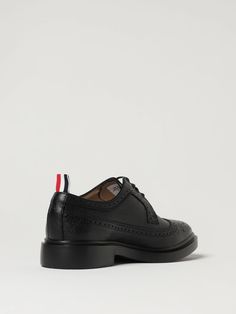 Classic Design  Grained Calfskin  Laceup  Round Tip  Dovetail Brogue Pattern  Waxed Cotton Laces  Reinforced Heel  Fabric Logo Flag Tie  Smooth Leather Interior  Logo Inlaid On The Insole  Rubber Sole Thom Browne Shoes, Black Brogues, Brogues Men, Interior Logo, Fabric Logo, Brogue Shoes, Leather Dress Shoes, Derby Shoes, Waxed Cotton