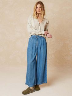 These wide leg jeans from indi & cold are cut from 100% lyocell with a denim wash. soft and fluid they feature a double pleat at the front french cut pockets at the front and two patch pockets at the back. designed for a slightly loose fit.    - 100% lyocell with denim wash  - relaxed fit  - double dart on the front to give width  - french cut pockets on the front  - patch pockets on the back  - button closure  - flat measures on size 36: rise length 31cm. inseam length: 62cm  - sizing: +1cm length per size and +2cm in chest/waist measurements  - made in portugal  - wash at low temperature  - do not tumble dry Relaxed Fit Medium Wash Tencel Bottoms, Light Wash Tencel Straight Leg Bottoms, Relaxed Fit Denim Blue Tencel Jeans, Versatile Denim Wide Leg Pants For Spring, Versatile Wide Leg Denim Pants For Spring, Casual Wide Leg Tencel Jeans, Medium Wash Tencel Wide Leg Bottoms, Relaxed Fit Denim Blue Tencel Bottoms, Wide Leg Tencel Bottoms In Medium Wash