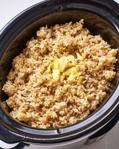 rice and butter in the crock pot ready to be cooked