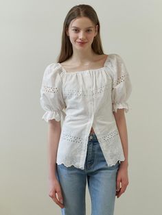 This clothing item is a dress with dramatic puff sleeves and an off-the-shoulder neckline. It features a button-up front and is adorned with eyelet lace detailing throughout, providing a see-through effect on the sleeves and hem. The hemline showcases a scalloped edge, enhancing the dress's feminine charm.- The eyelet lace detailing creates a delicate and airy feel, perfect for warm weather.- Its off-the-shoulder design and puff sleeves add a trendy and romantic touch.- The scalloped hemline con Chic Eyelet Blouse For Daywear, Spring Eyelet Blouse For Daywear, Summer Daywear Blouse With Eyelet Details, Chic Fitted Eyelet Blouse, Chic Puff Sleeve Blouse With Broderie Anglaise, Chic Broderie Anglaise Puff Sleeve Blouse, Feminine Fitted Blouse With Eyelet Details, Feminine Fitted Eyelet Blouse, Spring Square Neck Top With Broderie Anglaise