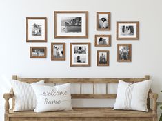 a wooden bench sitting in front of a wall filled with pictures