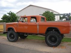 an orange truck parked in front of a house