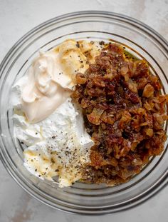 a glass bowl filled with different types of food