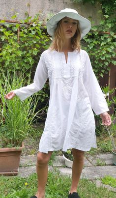 COMFORTABLE white beach dress with handmade cotton embroidery is very easy to wear. this super soft cotton is very pleasant especially in summer! for a beach outing with a swimsuit, by the pool, in the evening for a restaurant with jeans or shorts! .. VERSATILE soft 100% cotton white dress is very popular beach tunic for lazy days in your house, to go shopping or even for a party.. the embroidery is incredible. it is an elegant piece, which requires a unique know-how. TIMELESS classic casual wom White Bohemian Tunic With Chikankari Embroidery, White Cotton Tunic With Floral Embroidery, White Cotton Tunic For Beach Cover-up, White Chikankari Embroidered Summer Dress, White Chikankari Embroidery Summer Dress, White Chikankari Embroidery Dress For Summer, Casual Cotton Embroidered Beach Dress, White Cotton Summer Tunic, Beach Cotton Tunic With Floral Embroidery