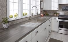 a kitchen with white cabinets and stainless steel appliances