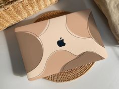 an apple ipad is sitting on a wicker tray next to a woven basket and pillow