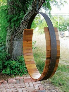 a circular wooden bench sitting next to a tree