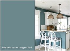 the kitchen is painted in blue and white with two pendant lights above the bar stools