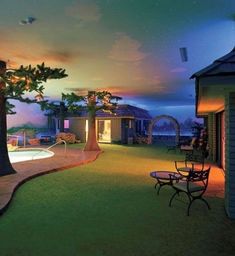 an outdoor swimming pool surrounded by trees and lawn furniture at night with stars in the sky