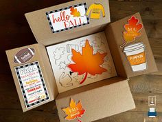 an open cardboard box with some fall stickers on it