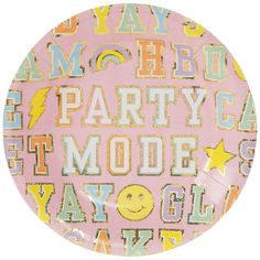 a pink party plate with smiley faces and words on the front, in various colors