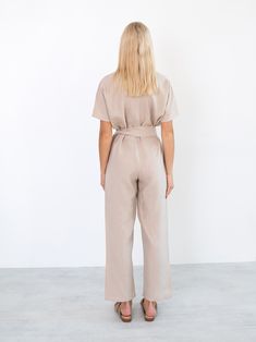 "AURORA is a short sleeve jumpsuit with belt. DETAILS - Wrap style top - Dolman sleeves - Self tie belt - 100% lightweight European linen fabric - Cut and sewn to order just for you in our studio COLOR - Beige, you can also choose other colors above - Fabric samples are available here https://www.etsy.com/listing/586569696/linen-fabric-samples SIZING & FIT - Fits true to size - Inseam is approximately 28.5 inches / 72 cm - Bust is approximately 21 inches / 49.5 cm - Waist is approximately 18 Chic Beige Belted Jumpsuit, Belted Short Sleeve Jumpsuits For Work, Belted Short Sleeve Jumpsuits And Rompers For Work, Short Sleeve Belted Jumpsuits And Rompers For Work, Workwear Jumpsuit With Tie Waist And Relaxed Fit, Short Sleeve Jumpsuits And Rompers For Workwear, Workwear Jumpsuits With Short Sleeves And Belt Loops, High Waist Belted Jumpsuits For Workwear, Belted Relaxed Fit Jumpsuit For Work