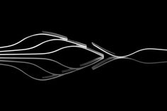 a black and white photo of forks in the dark with reflections on the water's surface