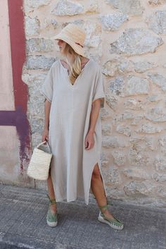 Style // Whether you call it beige, cream, off-white, one thing is for sure - our Moon tone is absolutely perfect! When comfort meets style, the Cala Kaftan features a billowy, shapeless silhouette and mid-length. With a v-neck silhouette, wide sleeves and two side slits, it promises to be your go-to look for that cozy, effortless look. The lightweight linen-cotton blend fabric is extra soft, to ensure you won't ever want to take it off. Fit Note: Available in one size fits most. Bust: 64" Lengt Casual V-neck Kaftan For Daywear, Casual Beige Kaftan For Spring, Beige Kaftan For Spring Daywear, Beige Kaftan For Summer Loungewear, Beige Summer Kaftan For Loungewear, Oversized Neutral Summer Dress, Beige V-neck Kaftan For Vacation, Casual V-neck Kaftan For Loungewear, Casual V-neck Kaftan With Relaxed Fit