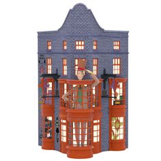 the doll house is made out of plastic and features an orange tower with two stories