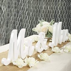 the table is decorated with flowers and white letters