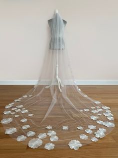 a wedding veil with white flowers on it