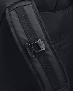 a close up view of the zippers on a black backpack with a metal buckle