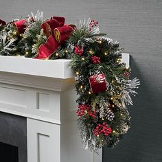 a christmas wreath on top of a fireplace