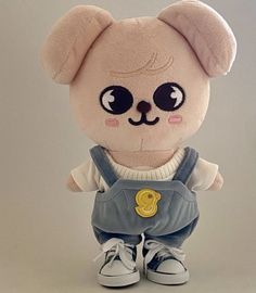 a teddy bear with big eyes and overalls