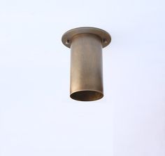 a close up of a light fixture on a white wall with a sky in the background