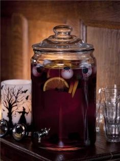 a glass jar filled with liquid sitting on top of a table