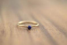 "Beautiful birthstone lapis lazuli stacking ring. Made in 14k gold filled and stones are 3mm. This ring is made to order in your size. If you don't see your size available please feel free to message me. Also available with garnet, carnelian, moonstone, turquoise, or simulated opal. Put your birthstone choice in \"Notes to Seller\" at checkout. Please message me for availability and pricing if interested in a stone not listed. All orders ship in a gift box. If you are ordering multiple items and Yellow Gold Lapis Lazuli Minimalist Jewelry, Minimalist Yellow Gold Lapis Lazuli Jewelry, Minimalist Round Lapis Lazuli Jewelry, September Birthstone Ring, September Birthstone Rings, Lapis Lazuli Ring, Gold Ring Stack, September Birthstone, Ring Gemstone