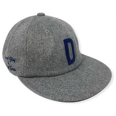 a grey hat with blue stitching on the front and side panel, sitting against a white background