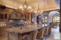 a large kitchen with an island and chandelier