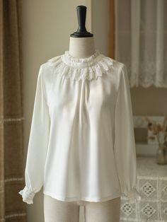 A jumper skirt and high neck ribbon blouse that gives you the feel of an elegant British young lady. The waist part is decorated with a shiny gold buckle, and the shoulder straps, chest area, and hem are decorated with lace embroidery. The high-necked blouse is decorated with lace and frills, giving it a noble feel. The ribbon on her chest is removable. 
 
 Item 
 
 Jumper skirt 
 Blouse (white) 
 Blouse (beige) 
 
 
 
 Size 
 
 Jumper skirt 
 
 XS size 
 
 Length: 113cm 
 Upper body length: 38c White Office Lady Blouse For Party, Elegant Blouse With Lace Trim And Doll Collar, Elegant Doll Collar Top For Daywear, Elegant Blouse With Doll Collar For Daywear, Elegant Doll Collar Blouse For Spring, Elegant Doll Collar Blouse For Daywear, Elegant White Top With Peter Pan Collar, Elegant White Blouse With Peter Pan Collar, Elegant Doll Collar Blouse For Workwear