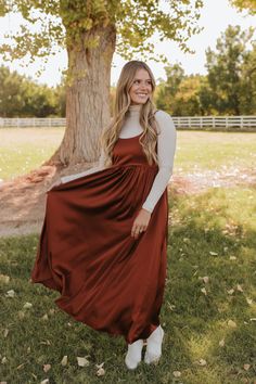 Get ready to turn heads in THE ADA SATIN MIDI DRESS! In a captivating amber color, this pretty dress is perfect for any occasion. With a midi length and skinny straps, it's both elegant and flirty. Plus, the tie back adds a touch of uniqueness to your outfit. A must-have for your wardrobe! Paired with THE CONNER RIBBED TURTLE NECK IN TAUPE & THE MIMI COWGIRL BOOTS IN WHITE Scoop neck Spaghetti strap Tie back Midi length 97% polyester, 3% spandex Dress runs true to size. Small (2-4), Medium (6-8) Chic Fall Maxi Dress For Prom, Elegant Spaghetti Strap Dresses For Fall, Midi Length Suspender Dress For Date Night, Brown Maxi Dress For Date Night In Fall, Elegant Slip Dress For Date Night In Fall, Fall Evening Dresses With Spaghetti Straps, Evening Spaghetti Strap Dresses For Fall, Spaghetti Strap Evening Dresses For Fall, Chic Brown Midi Dress With Spaghetti Straps