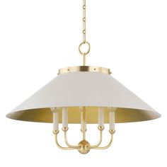 a brass chandelier with white shades