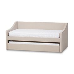 the day bed with pull out trundle is shown in white linen and has a mattress underneath it