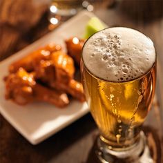 a glass of beer and some food on a table