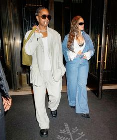 a man and woman walking through an airport