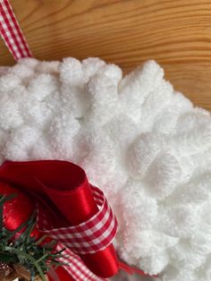 a red and white christmas decoration on a wooden table