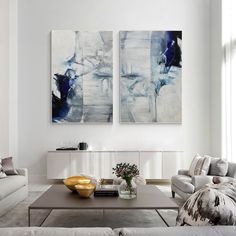 a living room with two paintings on the wall