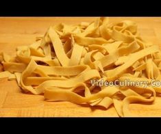 raw uncooked pasta on a wooden cutting board with the words video culinary com