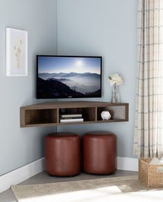 a flat screen tv sitting on top of a wooden shelf