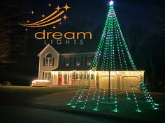 a lighted christmas tree in front of a house with the words dream lights above it